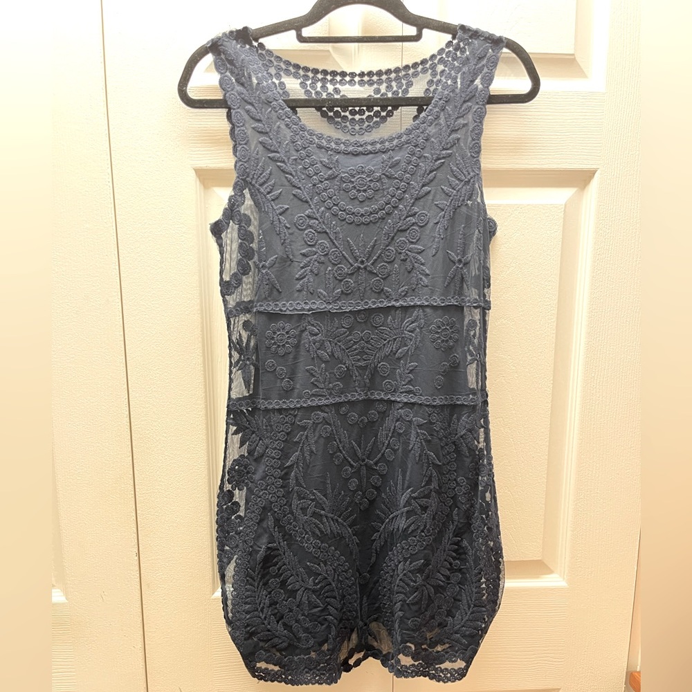 Navy blue fitting dress with high neck lace overlay tank top lining.